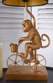 małpka na rowerze czarno-złota lampa